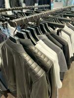 clothes on a hanger in a store for men photo