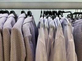Clothes hang on a hanger for women. Style and wardrobe. Shopping center and shopping. photo