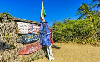 Puerto Escondido Oaxaca Mexico 2023 Sun beach sand people surfer waves palms Puerto Escondido Mexico. photo