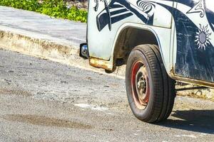 Playa del Carmen Quintana Roo Mexico 2021 Old black broken dirty VW bus Volkswagen car rusting Mexico. photo