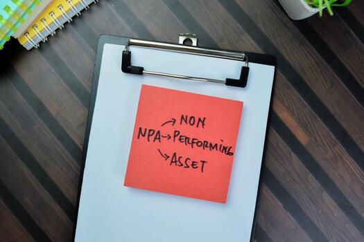 Concept of NPA - Non Performing Asset write on sticky notes isolated on Wooden Table. photo