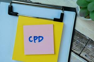 Concept of CPD write on sticky notes isolated on Wooden Table. photo