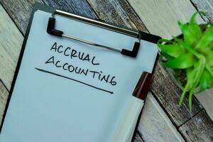 Concept of Accrual Accounting write on paperwork isolated on Wooden Table. photo