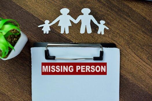 Concept of Missing Person write on paperwork on a book isolated on Wooden Table. photo