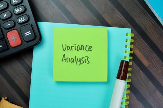 Concept of Variance Analysis write on sticky notes isolated on Wooden Table. photo