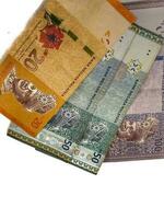 Isolated white photo of some malaysian ringgit banknotes.