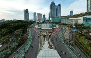 Aerial view of the A crowd of people enjoy Sunday morning near Bunderan Hotel Indonesia area. Car free day is finally back after the number of Covid-19. Jakarta, Indonesia, March 1, 2023 photo