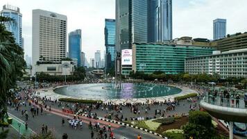 Aerial view of the A crowd of people enjoy Sunday morning near Bunderan Hotel Indonesia area. Car free day is finally back after the number of Covid-19. Jakarta, Indonesia, March 1, 2023 photo