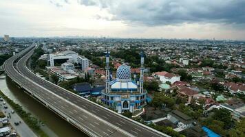 Al-azhar Center Mosque panorama view Largest Mosque in Bekasi. Ramadan and Eid Concept and noise cloud when sunset or sunrise view. Bekasi, Indonesia, March 1, 2023 photo