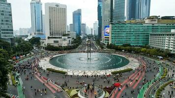 Aerial view of the A crowd of people enjoy Sunday morning near Bunderan Hotel Indonesia area. Car free day is finally back after the number of Covid-19. Jakarta, Indonesia, March 1, 2023 photo