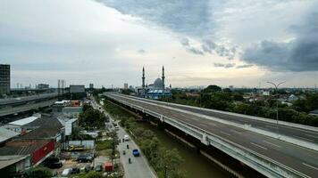 Al-azhar Center Mosque panorama view Largest Mosque in Bekasi. Ramadan and Eid Concept and noise cloud when sunset or sunrise view. Bekasi, Indonesia, March 1, 2023 photo