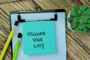 Concept of Discover Your Why write on sticky notes isolated on Wooden Table. photo