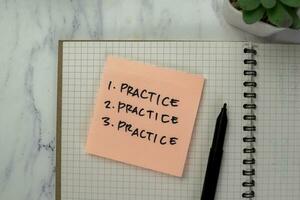 Concept of Practice, Practice, Practice write on sticky notes isolated on Wooden Table. photo