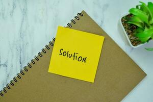 Concept of Solution write on book isolated on Wooden Table. photo
