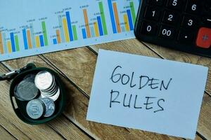 Concept of Golden Rules write on paperwork isolated on Wooden Table. photo