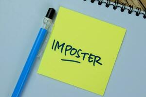 Concept of Imposter write on sticky notes isolated on Wooden Table. photo