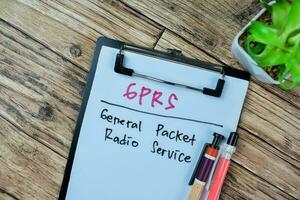 Concept of GPRS - General Packet Radio Service write on paperwork isolated on Wooden Table. photo