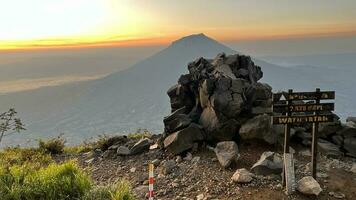 mountains under mist in the morning in sindoro mountain county. West Java, Indonesia, March 16, 2023 photo