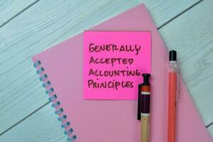 Concept of Generally Accepted Accounting Principles write on sticky notes isolated on Wooden Table. photo