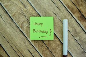 Concept of Happy Birthday write on sticky notes isolated on Wooden Table. photo