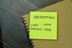 Concept of Credentials, Login and Password write on sticky notes isolated on Wooden Table. photo