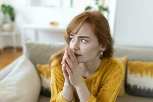 Sad woman feels miserable desperate sit on sofa look out the window thinking about personal troubles does not see way out of difficult life situation. Break up, heartbreak, cheated girl concept photo