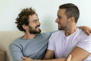 Two young man lgbtq gay couple dating in love hugging enjoying intimate tender sensual moment together kissing with eyes closed photo