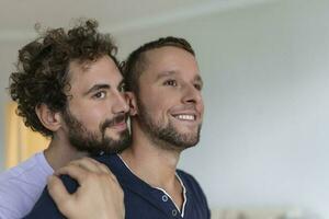 Portrait of Carefree Gay Couple Indoors. Happy gay couple spending time together photo