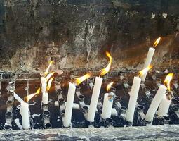 Prayers candle in one quite praying place, each candle represents the hope and spirit of the prayers photo