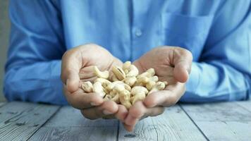 Young man hand hold cashew nuts video