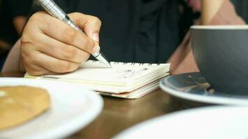 Close up of woman hand writing on notepad video