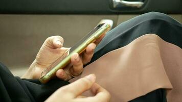 Woman hand holding smart phone in a car video