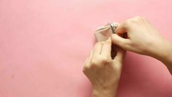 Woman's hand open an empty wallet on pink background video