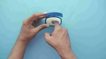 top view of man hand using petroleum jelly on blue background video