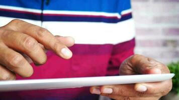 Man's hand working on digital tablet video