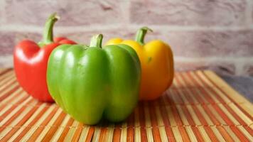 Yellow orange and red capsicum on white background video