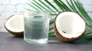 slice of fresh coconut and glass of coconut water on table video