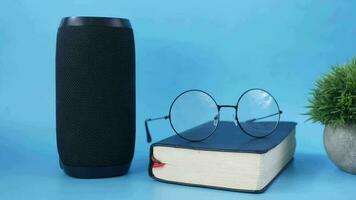 smart speaker and book on blue background video