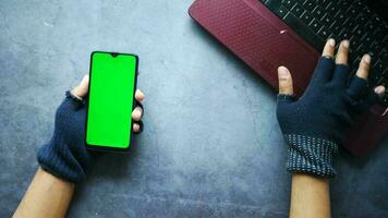 Hacker hand stealing data from smart phone video