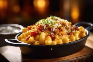 Appetizing mac and cheese in bowl with bacon on top baked in oven. photo