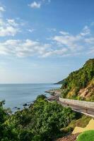 Beautiful seascape view with the mountain at noen nangphaya viewpoint chanthaburi thailand.Popular waterfront photo spot with a backdrop of the curving coastal road