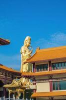 Guanyin goddress with temple rooftop and beautiful sky at foguangshan thaihua temple thailand.Fo Guang Shan is one of the four large Buddhist organizations in Taiwan photo