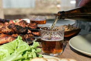 Summer picnic with barbecue, vegetables and beer in the country photo