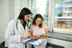 Happy carefree pregnancy. Obstetrics. Gynecology. Pregnant woman at obstetrician appointment in gynecological hospital photo