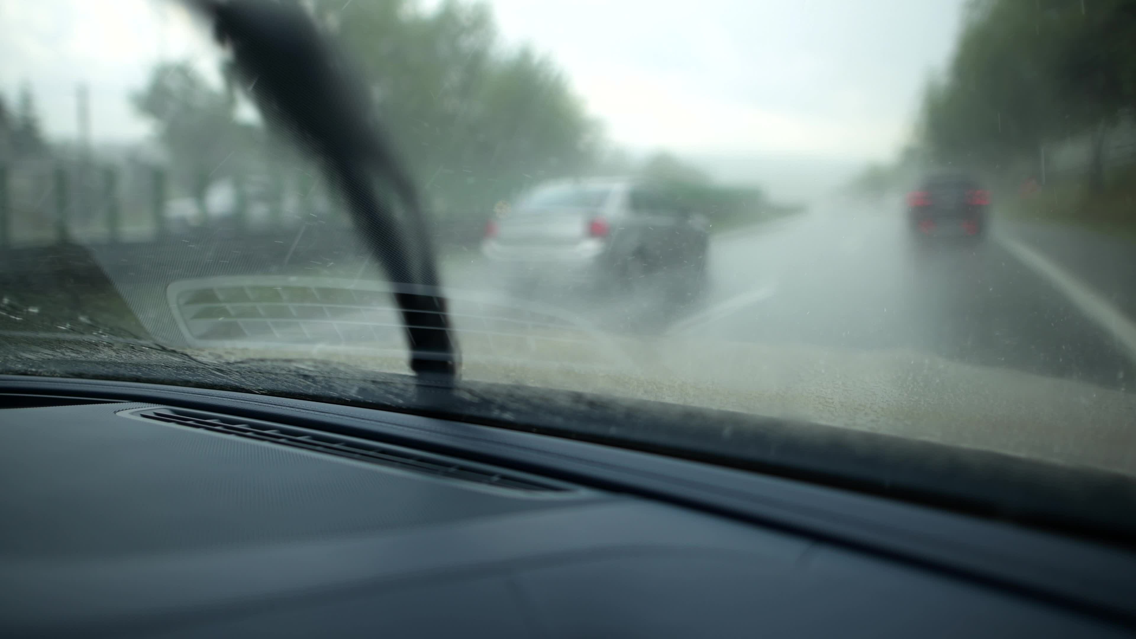 Running Windshield Wipers in Modern Car. Driving in Rain. 24698024