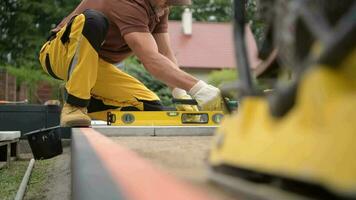 Worker Levelling Patio Concrete Floor Bricks Close Up Industrial video. Bricks Paving Theme. video