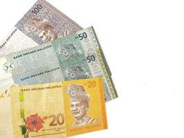 Isolated white photo of some malaysian ringgit banknotes.