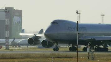 NOVOSIBIRSK, RUSSIAN FEDERATION OCTOBER 20, 2021 - Cargo Boeing 747 Sky Gates Airlines taxiing on the tarmac at Tolmachevo Airport, Novosibirsk OVB. Jumbo jet, close up video