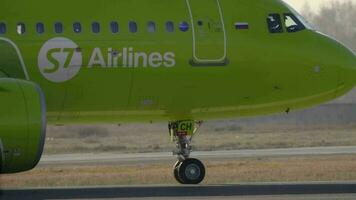 NOVOSIBIRSK, RUSSIAN FEDERATION OCTOBER 20, 2021 - S7 Airlines on the airfield at Tolmachevo airport OVB. Airliner Airbus A320 close up at the taxiway video