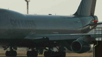 NOVOSIBIRSK, RUSSIAN FEDERATION OCTOBER 20, 2021 - Cargo Boeing 747 of Sky Gates Airlines taxiing at Tolmachevo Airport, Novosibirsk OVB. Jumbo jet on the taxiway, close up video